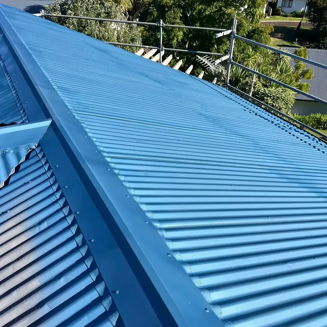 Freshly sprayed blue long-run steel roof in Auckland